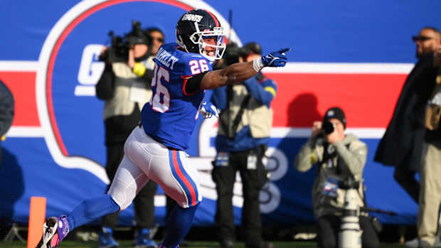 Dec 4, 2022; East Rutherford, New Jersey, USA; New York Giants running back Saquon Barkley (26) reacts to his touchdown run against the Washington Commanders during the first half at MetLife Stadium.